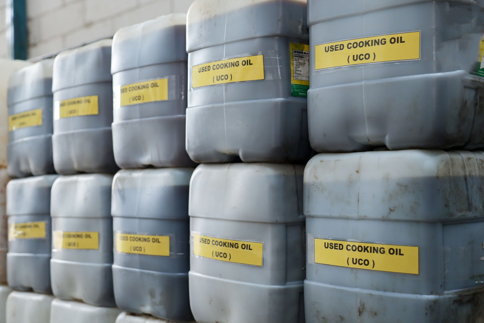 stock of used cooking oil in jerry cans.  used cooking oil collectors to reduce environmental pollution from household waste to be recycled into biodiesel raw materials