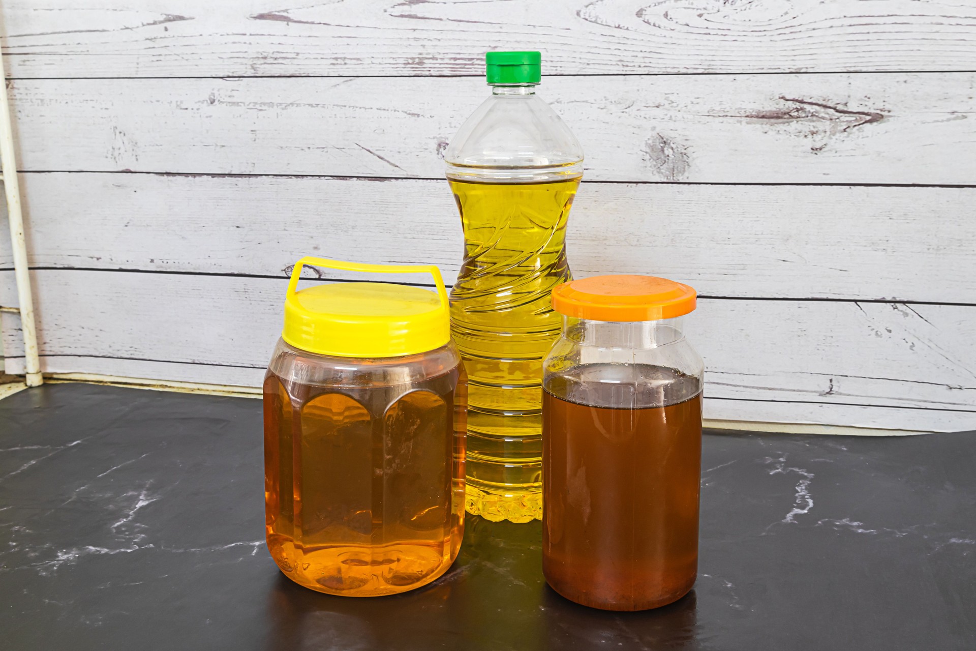 A bottle of vegetable or used cooking oil sits on the table. Old or used cooking oil can be recycled into biodiesel.